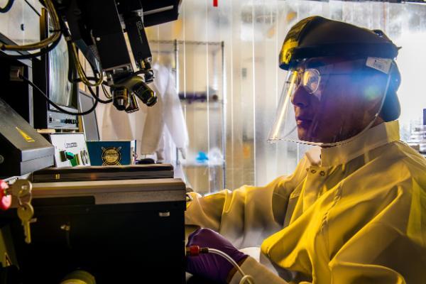 researcher at equipment in laboratory